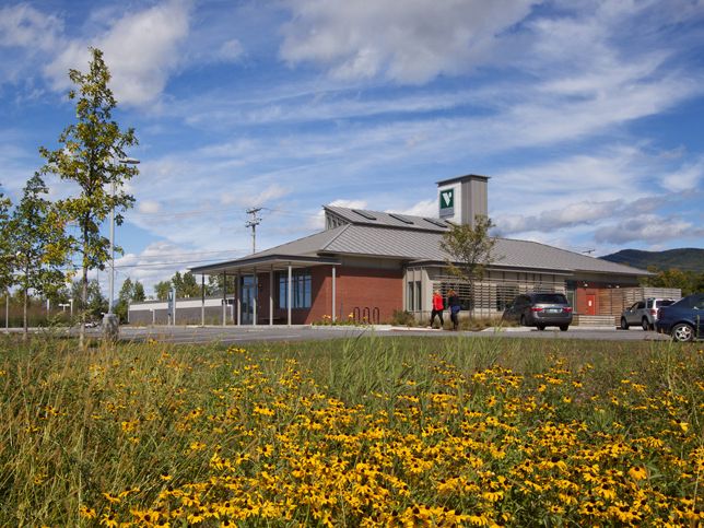 Hip-roofed masonry building with clerestory and deep porch