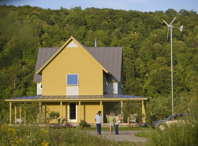 gable roofed wood frame house with clapboards and wrapping porch