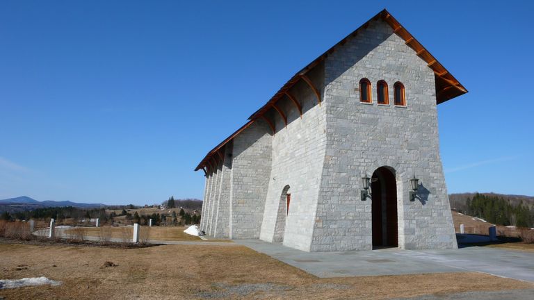 Tall, tapering stone masonry structure with bracketed, sloped roof