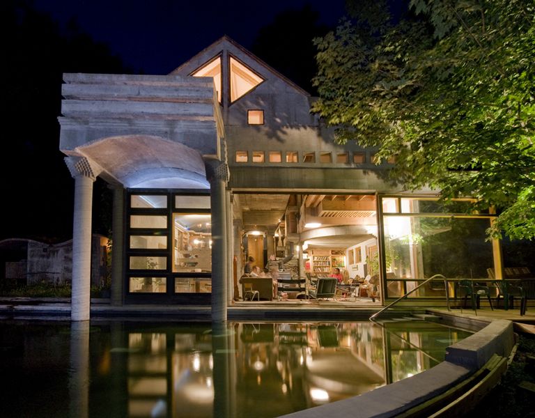 large gable roof house entirely of concrete with wood framed glass