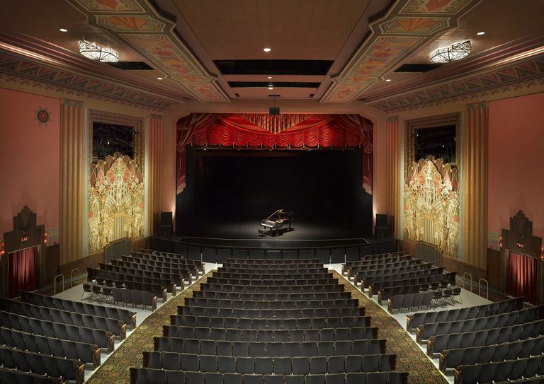 Rich, painted plaster and intracate stained glass panels adorn this restored theater interior