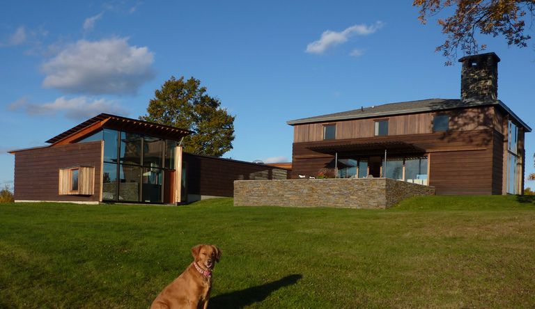 modern glazed shed roof building with stone walls