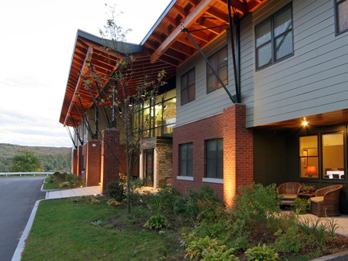 Masonry and clapboard sided building with 2-story entry