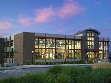 masonry and glass 2 story building with arched entry